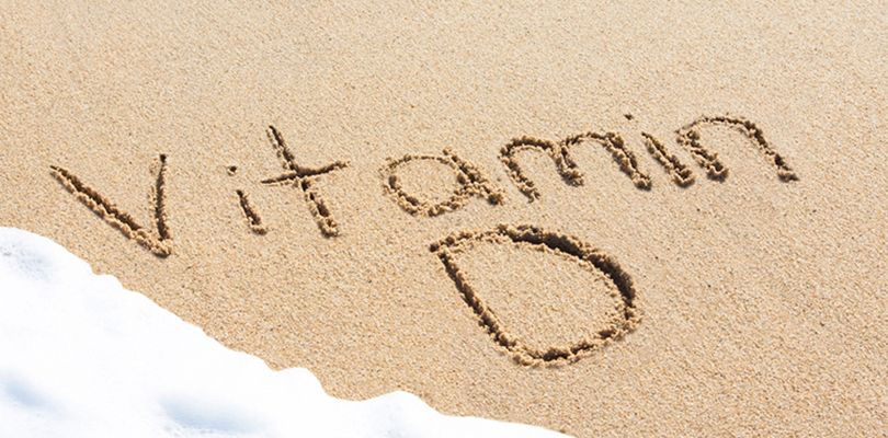 The words "Vitamin D" is written in sand