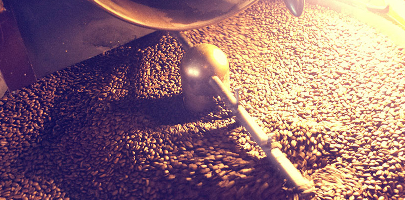 Coffee beans being grinned in a coffee grinder
