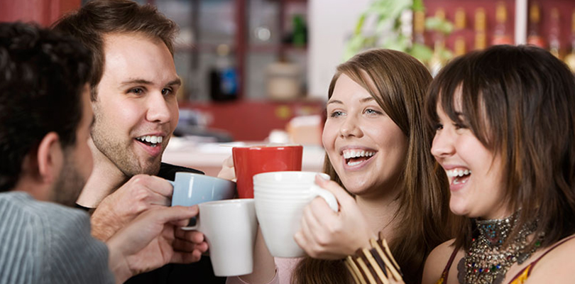 A group of friends are enjoying coffees together