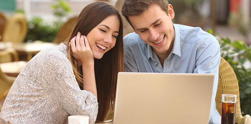 A couple is sitting next to each other and enjoying their time together