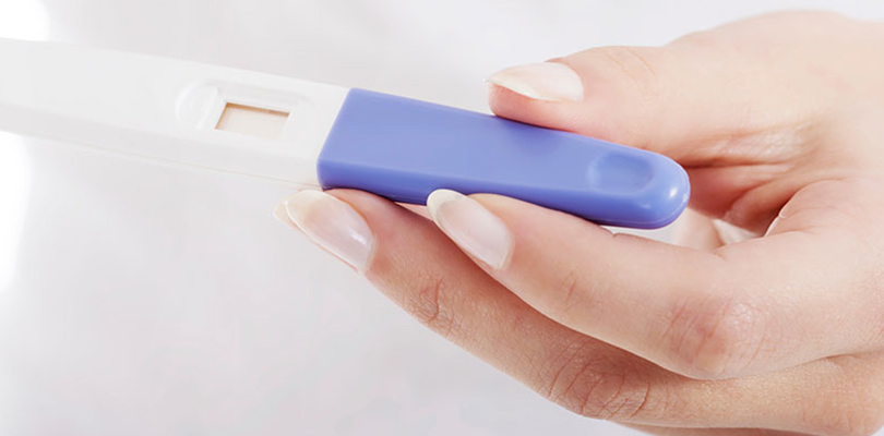 Woman is holding a pregnancy test in her hand