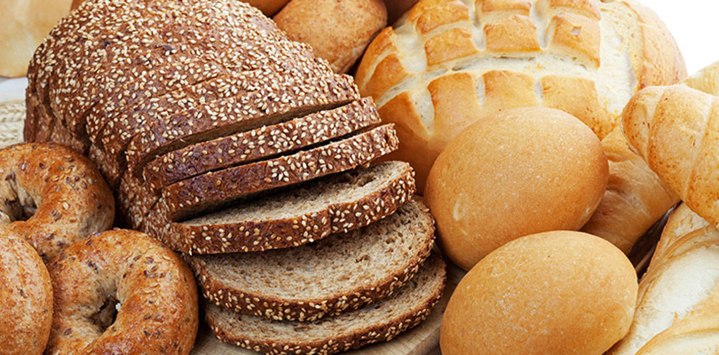 Various types of bread lay on a counter