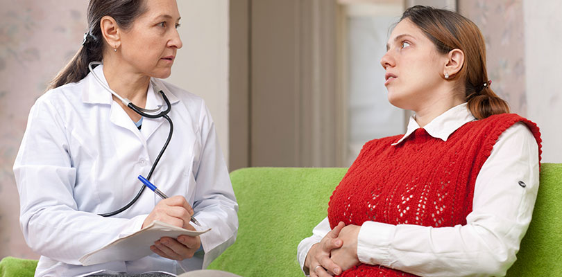 A patient discusses her symptoms with doctor