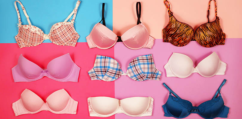Different sizes of bras on a colored background