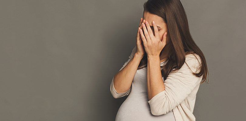 Crying pregnant woman