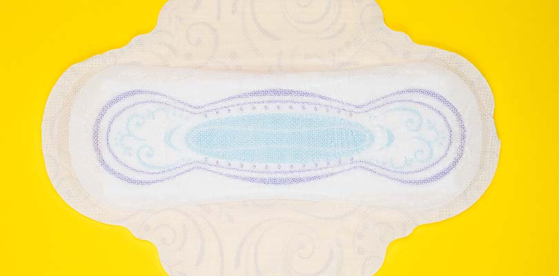 A clean period pad against a yellow background.